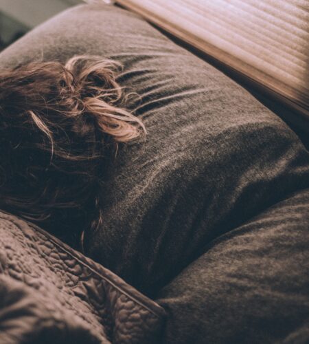 woman sleeping on bed under blankets