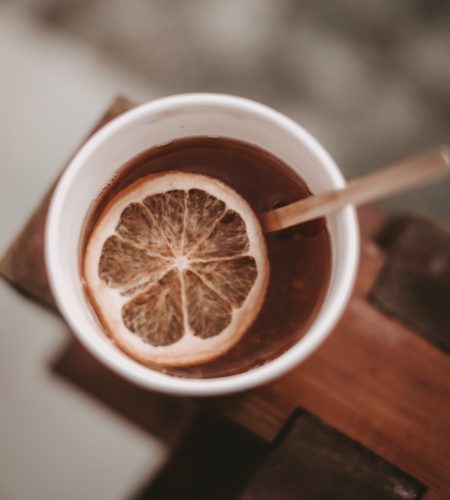 brown liquid in white ceramic mug with sliced lemon